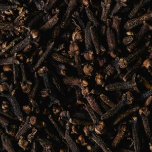 Close-up view of aromatic dried cloves, showcasing texture and rich brown color.